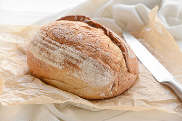 Loaf of sourdough bread on parchment