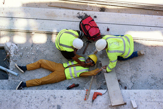Check Response and pulse, Life-saving and rescue methods. Accident at work of builder worker at Construction site. Heat Stroke or Heat exhaustion in body while outdoor work. First aid basic concept.