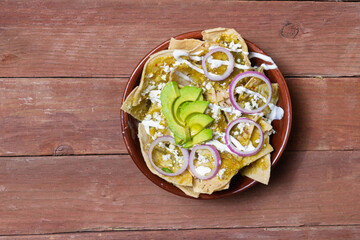 top view of mexican food. green chilaquiles with avocado