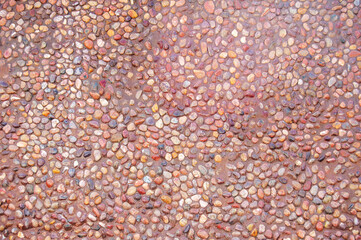 Transparent water flows down the pebbles. Pebble or gravel background or texture.