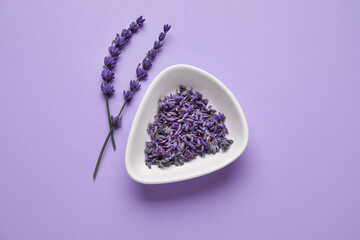 Obraz na płótnie Canvas Beautiful lavender flowers and bowl on color background