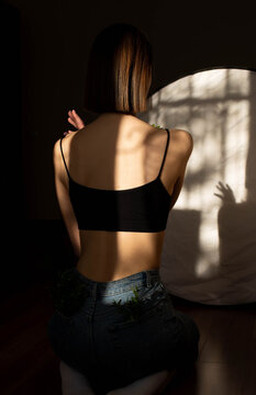 Beauty portrait of a back beautiful young girl with a shadow pattern on body in the form of stripes. fashion, beauty. A girl with anorexia turned back.