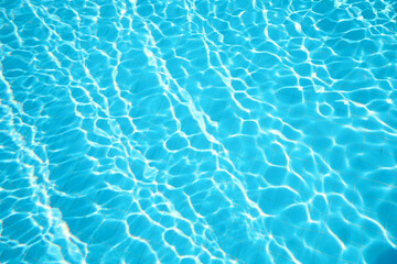 Fototapeta na wymiar Clear water in outdoor swimming pool on sunny day