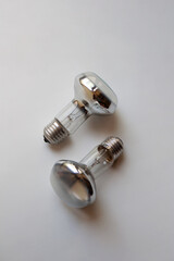 Two silver incandescent light bulbs isolated on white background