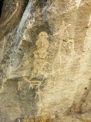 Ancient rock carvings petroglyphs of people with boat in Gobustan National park. Exposition of Petroglyphs in Gobustan near Baku, Azerbaijan.