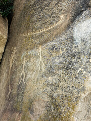 Ancient rock carvings petroglyphs of people with boat in Gobustan National park. Exposition of Petroglyphs in Gobustan near Baku, Azerbaijan.