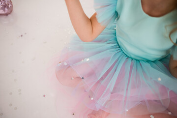 close-up of silver confetti stars on a festive tulle dress. Holiday accessories