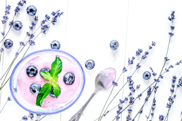 lavender flowers with blueberry yoghurt mock up on white background top view