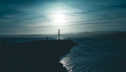 Dock of a port at sunset time with the sea calm