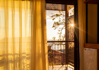 Sun shining into the room through the balcony