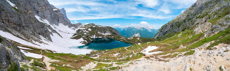 Naklejka na ściany i meble Beautiful mountain landscape, banner. Coldai lake overview. Italian Alps, Dolomites. Glacial lake on top of the mountain. Travel destination. Mountain panorama.