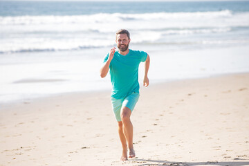 Male runner athlete run on sandy beach. Man running.