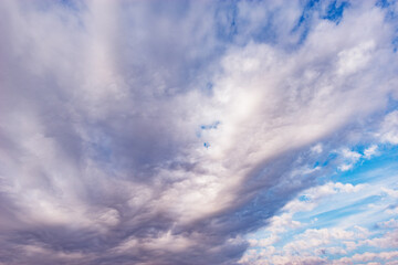 Naklejka na ściany i meble Stormy clouds on the blue sky.