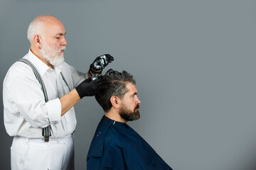 Professional hairdresser coloring man hair. Process of a guy color hair at hairdresser. Hair coloring man.