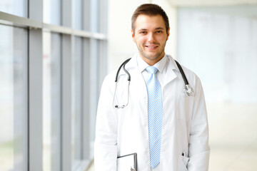 Male doctor standing in the modern clinic. Perfect medical service in the hospital. Medicine and healthcare concept