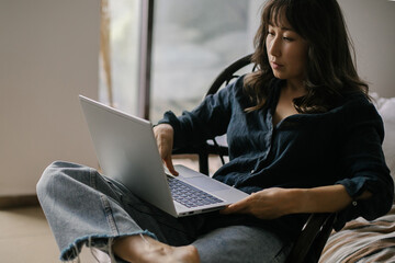 Female freelancer working remotely on laptop from home
