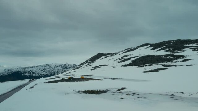 Aerial drone footage of basecamp with tents set up on high altitude in mountains