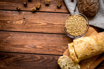 Baking homemade bread on wooden background top view moke up