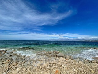 PETRČANE, CROATIA - June 2021. - Beautiful beach with rocks and pebbles in Petrčane near Zadar, Dalmatia on the Adriatic coast. Clean blue sea and sky