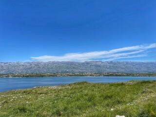 LJUBAČ, CROATIA, May 2021 - Remains of old church at the Ljubljana archaeological site and view toward Velebit mountain and Rtina