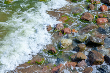 
Sea wave and wet stones, background
