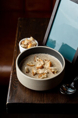 Palatable creamy button mushroom soup, top view for a commercial