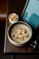 Palatable creamy button mushroom soup, top view for a commercial