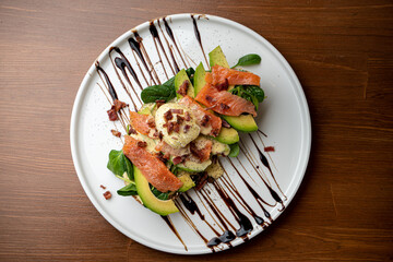 Avocado toast with baby spinach and benedict egg on top