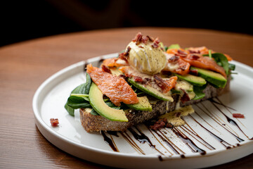 Avocado toast with baby spinach and benedict egg on top