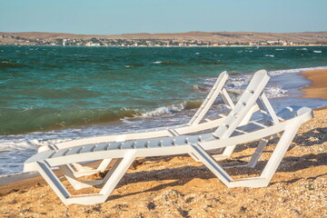 Sun loungers on a sandy beach by the sea