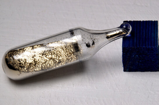 Sample of the Alkali metal Caesium, element number 55. This reactive metal can only exist in a sealed glass ampoule
