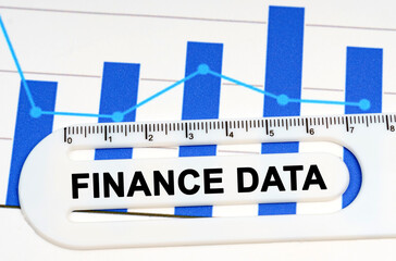 On the sheet with graphs there is a white ruler with the inscription - FINANCE DATA