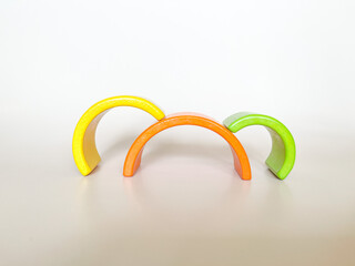 Wooden toys on a light background. The concept of child development according to the Montessori method. A colored rainbow. Previously, the development. Eco-friendly toys.