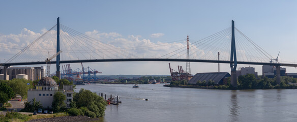 panorama of Hamburg Koehlbrand bridge over Elbe river with blue sky