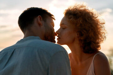 Portrait of young caucasian couple kissing tenderly