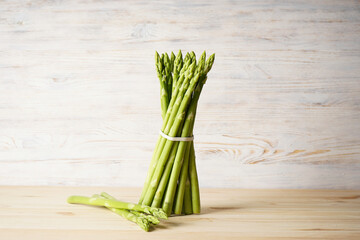 Fresh asparagus on a wooden background.