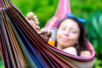 female is chilling and relaxing in the hammock, selective focus, focus on the feet