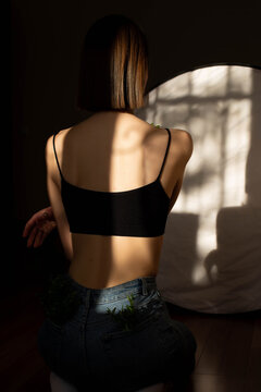 Beauty portrait of a back beautiful young girl with a shadow pattern on body in the form of stripes. fashion, beauty. A girl with anorexia turned back.