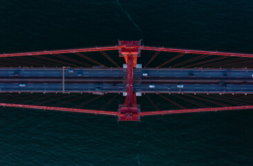 Aerial birds eye overhead top down view of cars driving on multilane road suspension bridge over Tagus river. Lisbon, Portugal. - Powered by Adobe