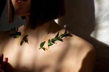 Beauty portrait of a beautiful young girl with a shadow pattern on the face and body in the form of...