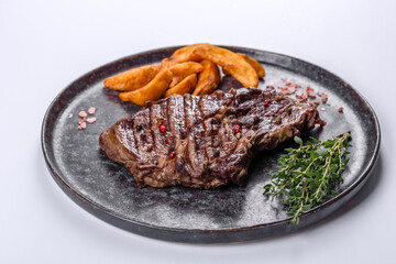 Delicious juicy fresh beef steak with spices and herbs on a white background