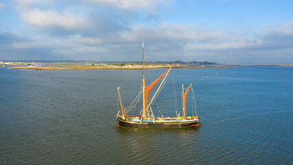 Beautiful aerial view on vintage caravel on sunlit sea water. Scenic travel concept, Brightlingsea, Essex, UK