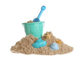 Plastic beach toys on pile of sand against white background. Outdoor play