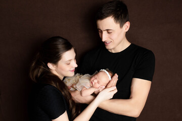 family portrait. mother and father with newborn baby. mom, dad and kids