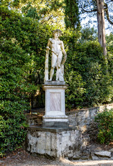 A statue depicting Bacchus or Dionysus, god of the grape-harvest, winemaking and wine, in Boboli Gardens, beside Palazzo Pitti, Florence city center, Tuscany region, Italy