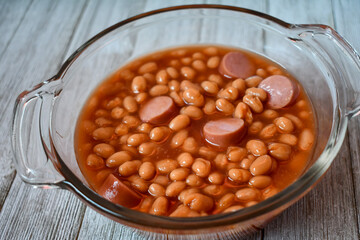 beans with hot dogs or franks and beans in a glass dish