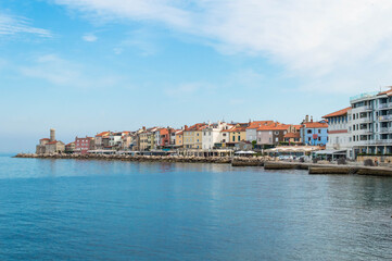Fototapeta na wymiar A panoramic of old historical Adriatic city of Piran, Slovenia. View over the tiled roofs of Piran and the Adriatic Sea.