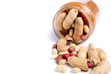 Peanut butter isolated and peanuts in the peel scattered on the white background. Copy space.