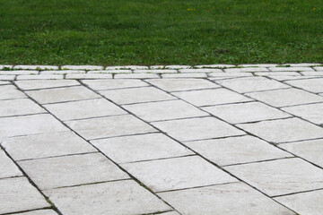 Fototapeta premium paving slabs on the background of a green lawn