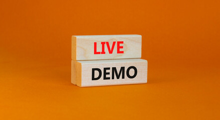 Live demo symbol. Concept words 'live demo' on wooden blocks on a beautiful orange background. Copy space. Business and live demo concept. - obrazy, fototapety, plakaty
